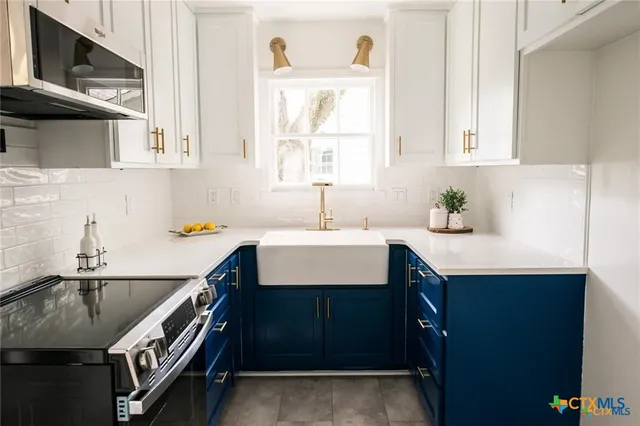 a kitchen with a sink a window and cabinets
