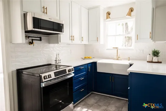 a kitchen with a sink stove and microwave