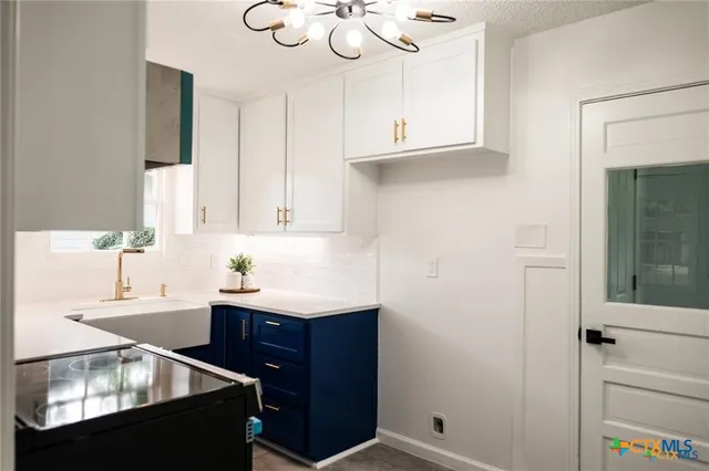 a kitchen with a sink cabinets and window