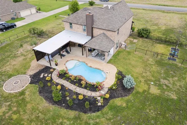 a view of a backyard with table and chairs and potted plants