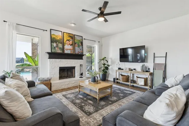a living room with furniture a fireplace and a flat screen tv