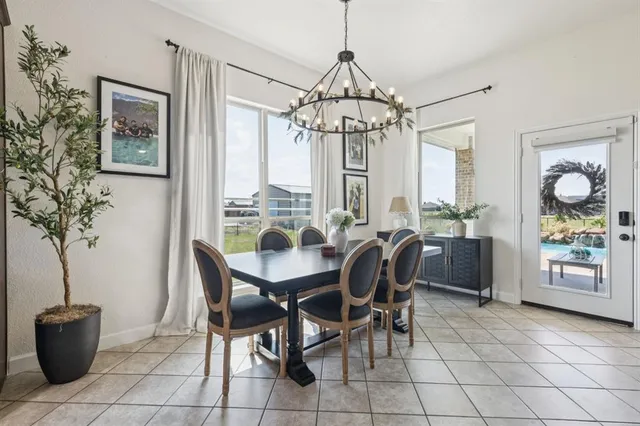 a view of a dining room with furniture and chandelier