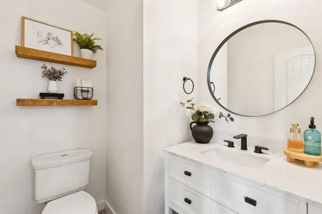 a bathroom with a toilet sink and mirror