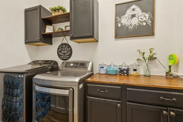 a utility room with a sink a stove and cabinets