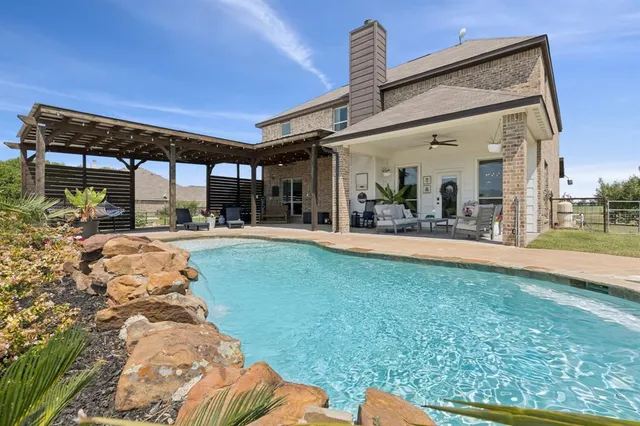 a view of swimming pool with a patio