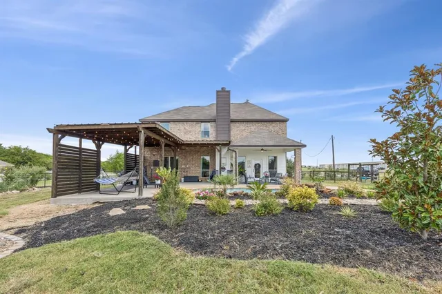 a view of a house with backyard porch and sitting area