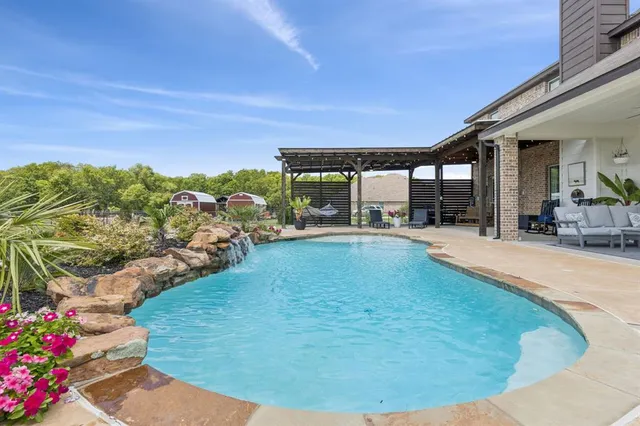 a view of a swimming pool with an outdoor seating