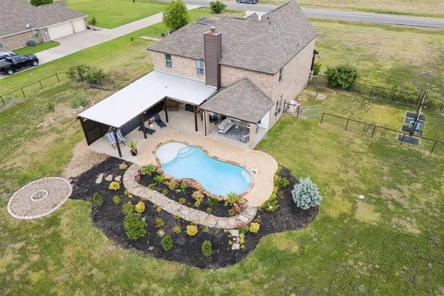 a view of a backyard with table and chairs and potted plants