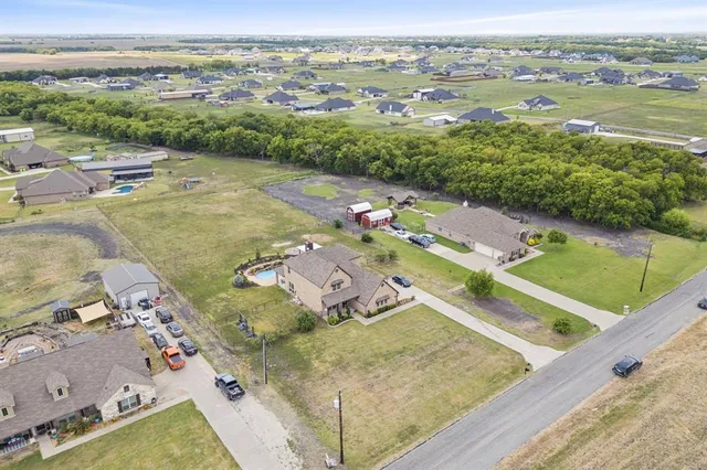 an aerial view of a house with a lake