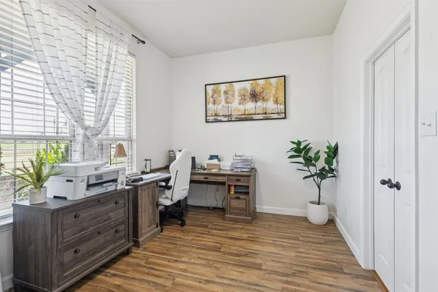 a view of a bathroom with a sink a mirror and a window