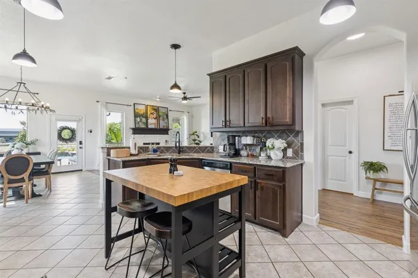 a view of kitchen with sink table and chairs