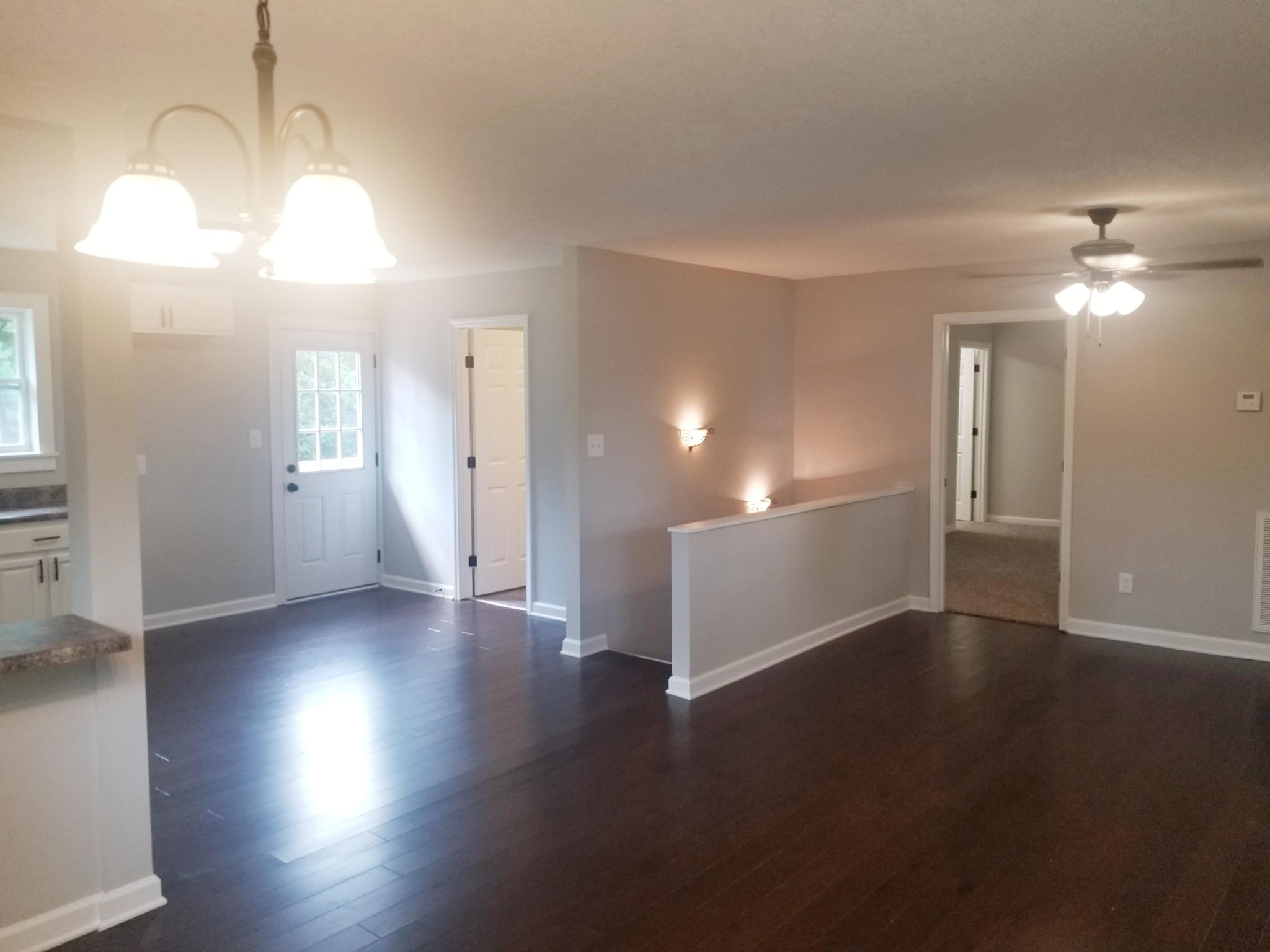 1007 Seed Tick Road Philadelphia, TN 37846 - Photo 3 of 16 an empty room with wooden floor and windows