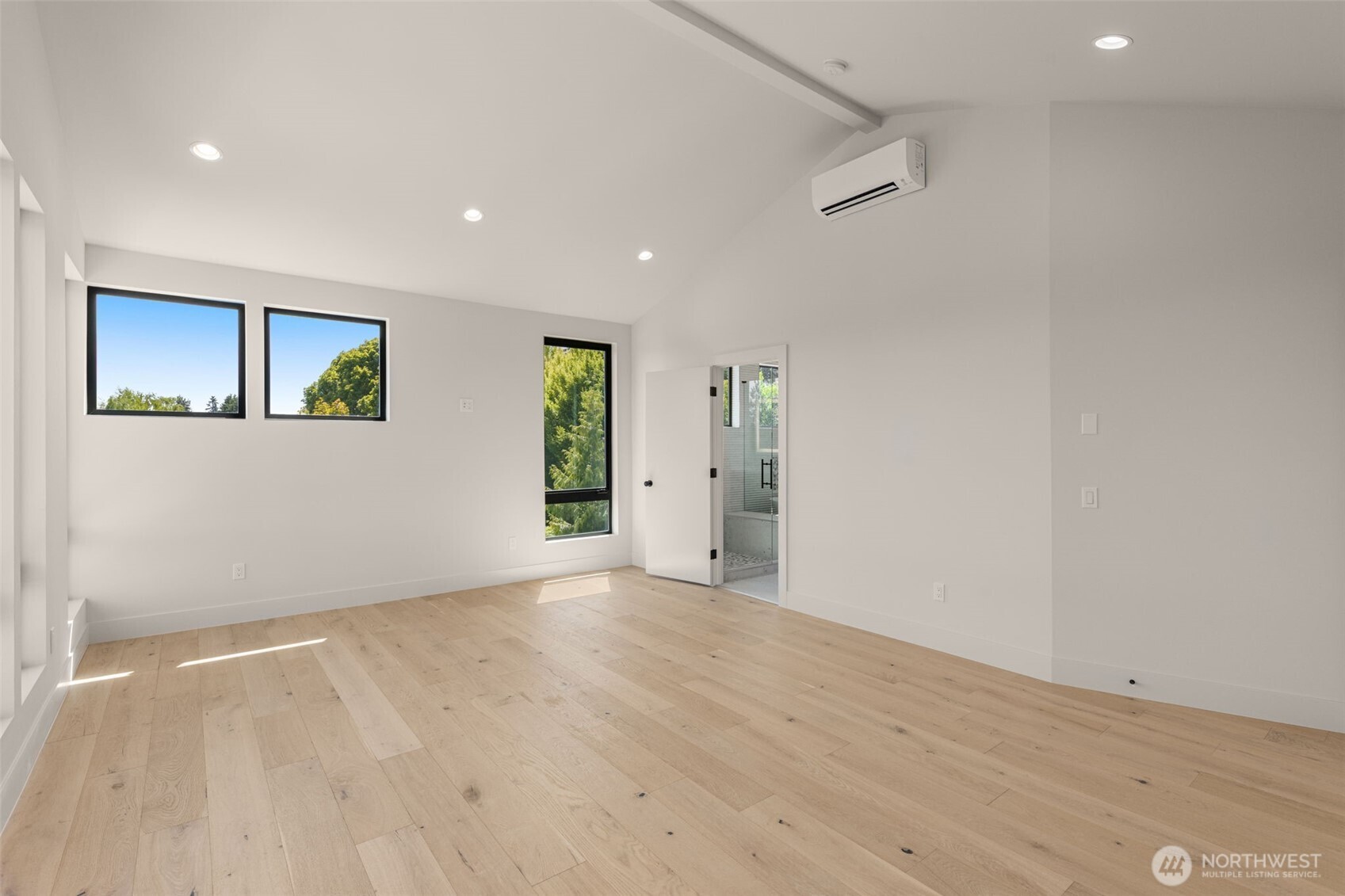 6833 36th Avenue Northeast Seattle, WA 98115 - Photo 12 of 40 an empty room with wooden floor and windows