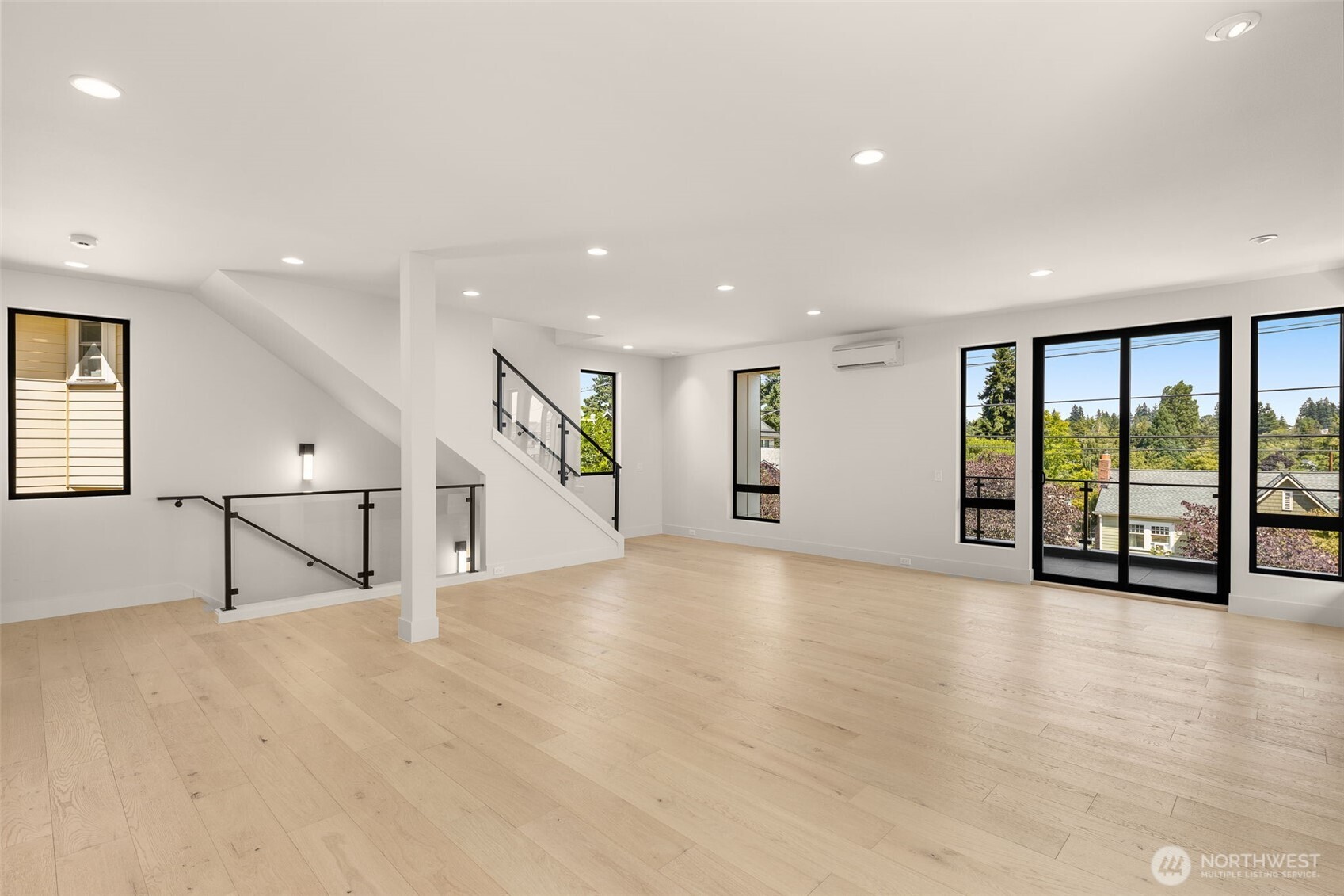 6833 36th Avenue Northeast Seattle, WA 98115 - Photo 2 of 40 an empty room with large window and stairs