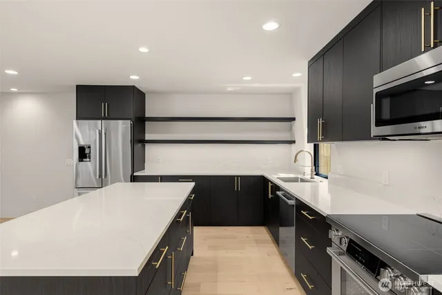 a kitchen with stainless steel appliances a refrigerator and a sink