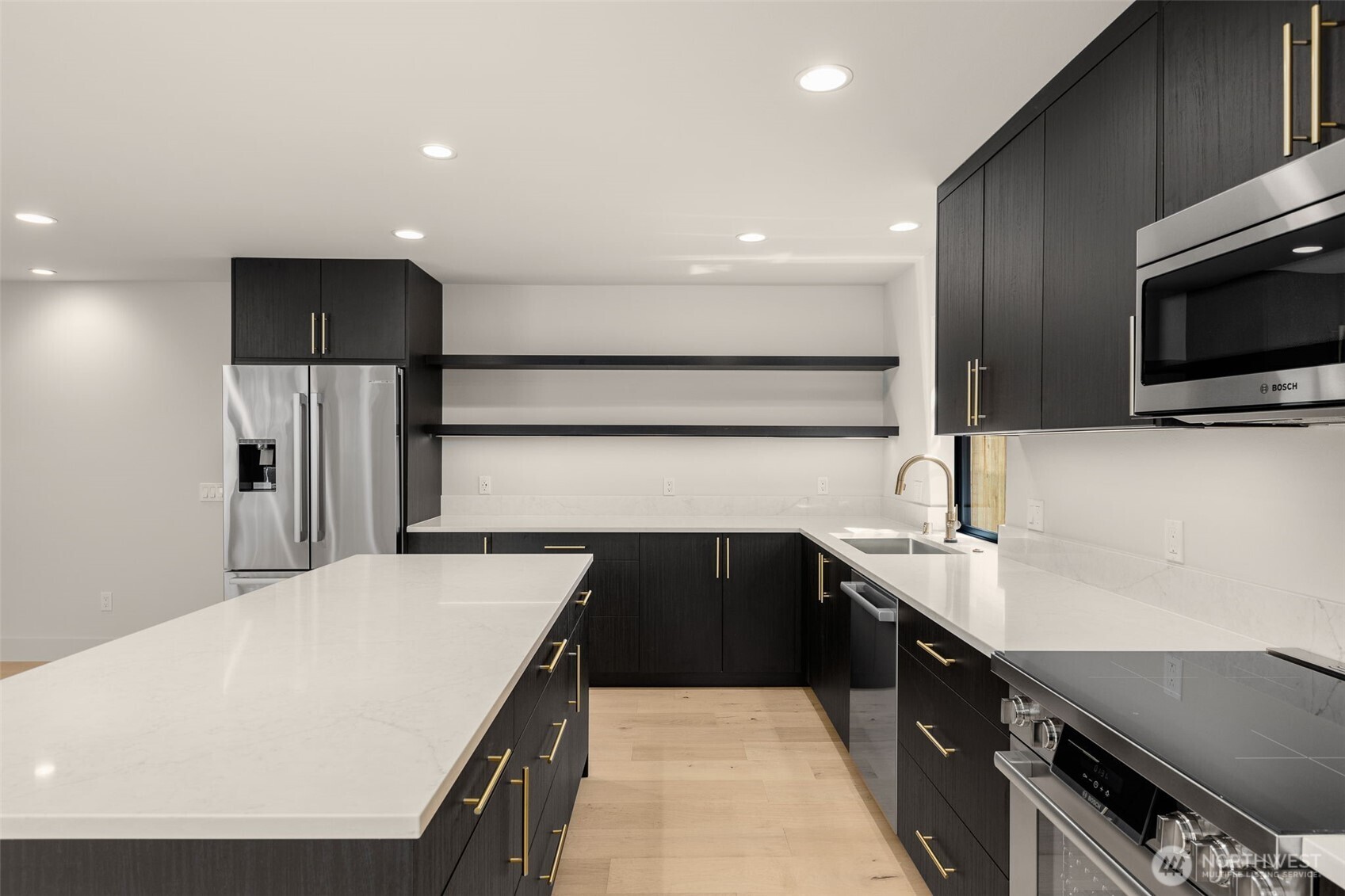 6833 36th Avenue Northeast Seattle, WA 98115 - Photo 22 of 40 a kitchen with kitchen island a sink stainless steel appliances and cabinets