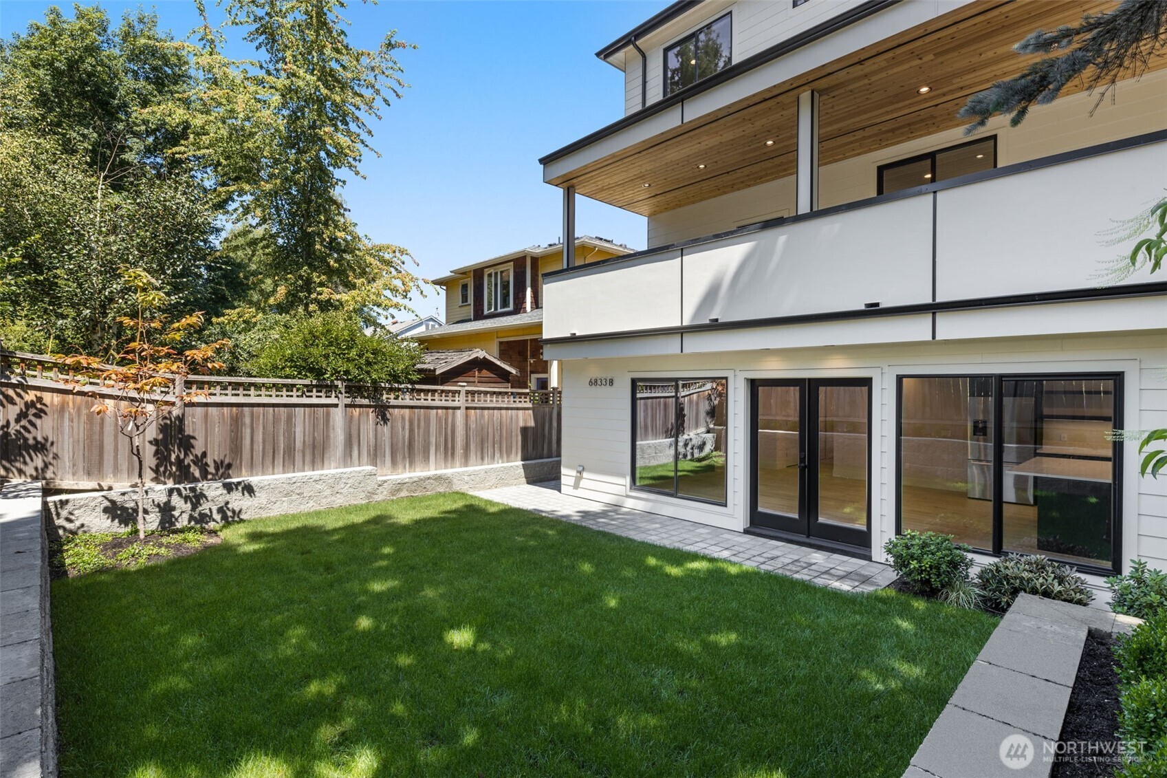 6833 36th Avenue Northeast Seattle, WA 98115 - Photo 35 of 40 a backyard of a house with yard table and chairs