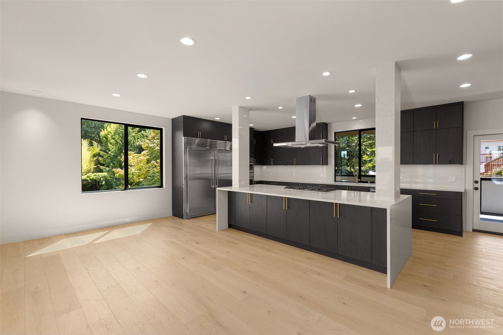 6833 36th Avenue Northeast Seattle, WA 98115 - Photo 6 of 40 a large kitchen with stainless steel appliances kitchen island a large counter top and a refrigerator