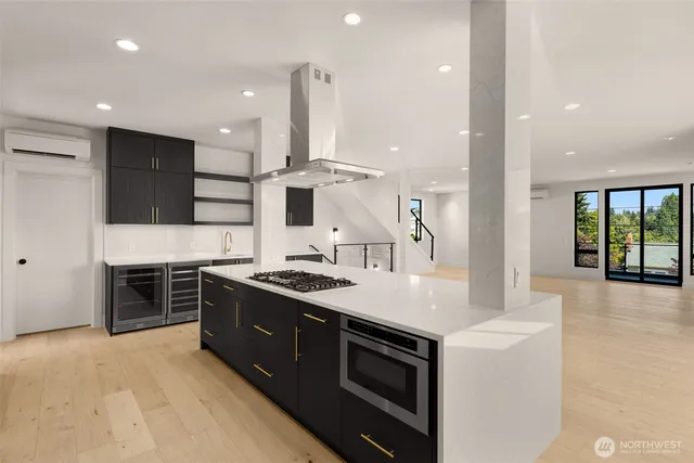 a large kitchen with stainless steel appliances granite countertop a stove and a sink