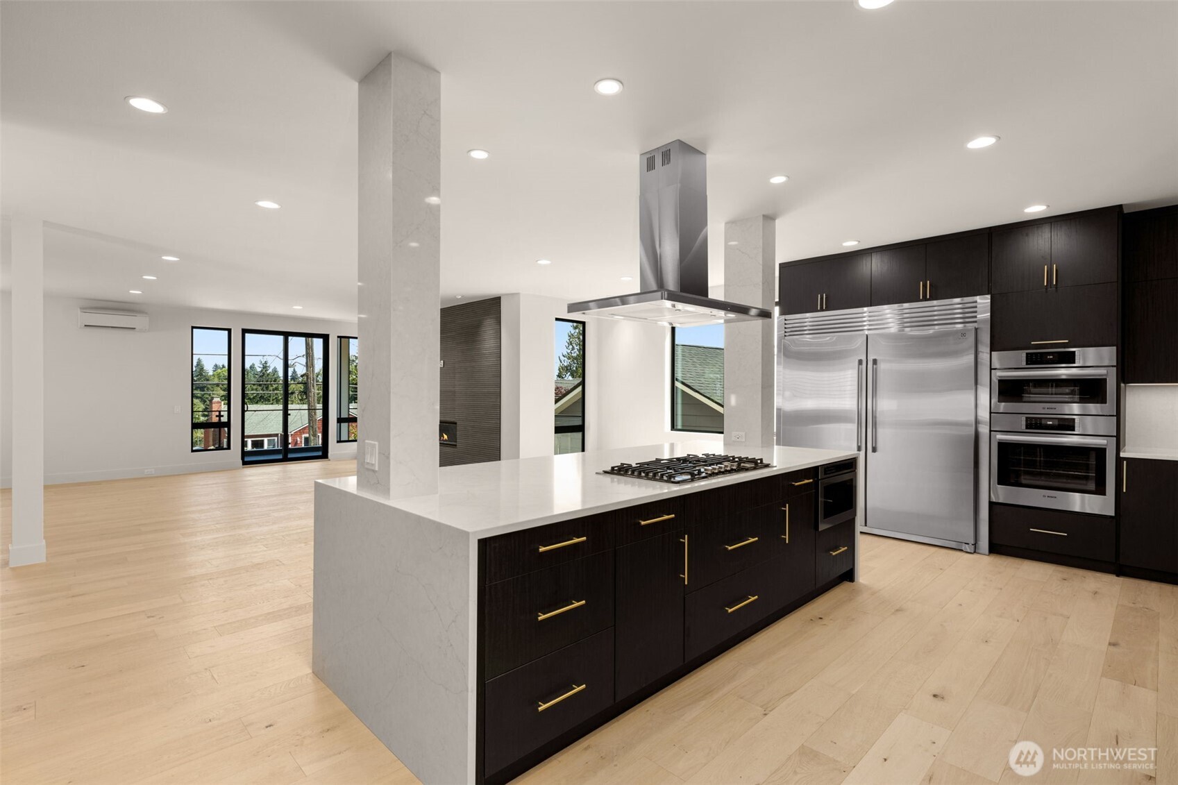 6833 36th Avenue Northeast Seattle, WA 98115 - Photo 9 of 40 a large kitchen with stainless steel appliances a large counter top a stove and a refrigerator