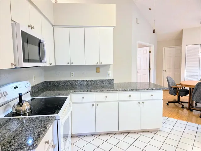 a kitchen with stainless steel appliances granite countertop a sink and a stove