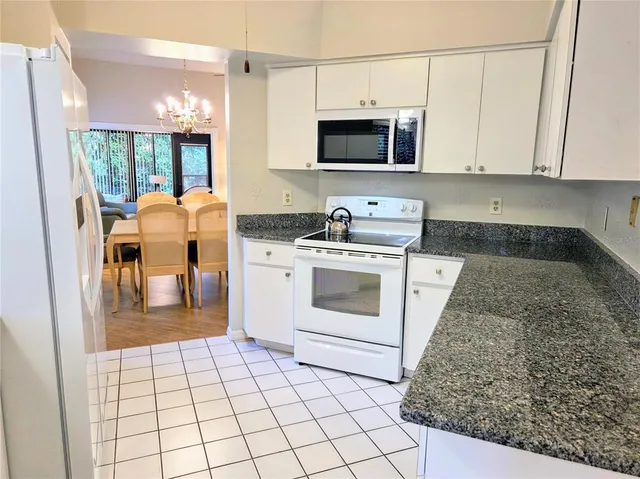 a kitchen with a stove a sink and a microwave