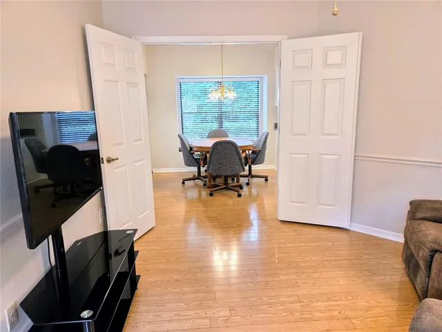 a living room with furniture window and wooden floor