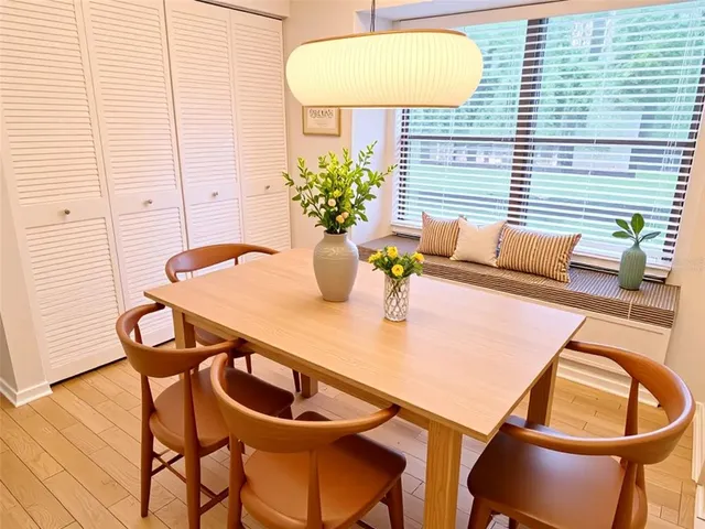 a dining room with furniture and wooden floor