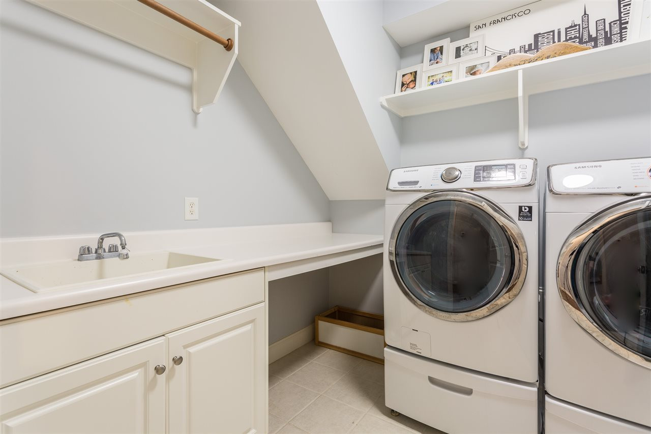 1716 Stannard Trail Raleigh, NC 27612 - Photo 25 of 30 The laundry room offers cabinet storage, folding table, and a rod for hanging wet clothing. Second Floor Laundry Room