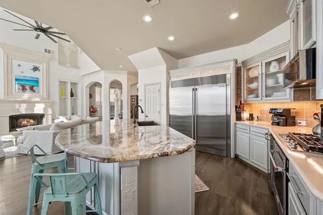 a kitchen with counter top space and living room