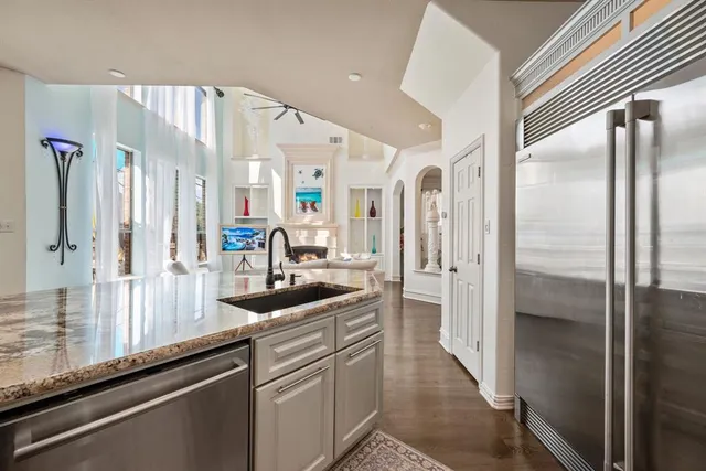 a bathroom with a sink a toilet a mirror and shower