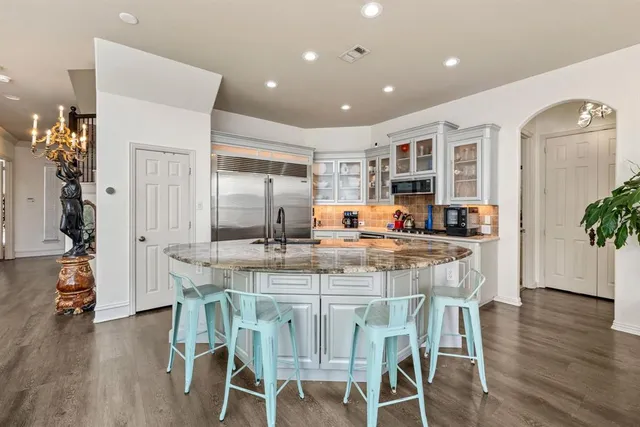 a view of a hallway with wooden floor and stairs