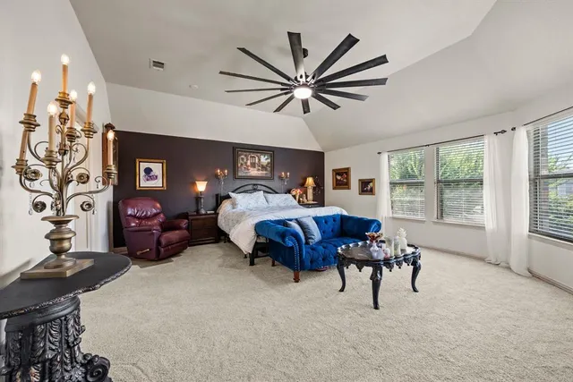 a bedroom with a large bed and a window