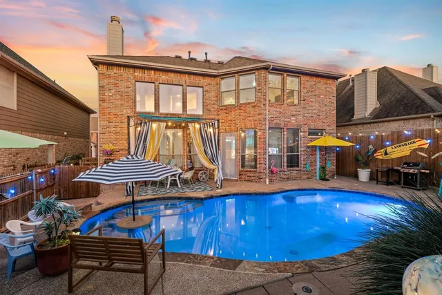 a view of backyard with seating space and trees