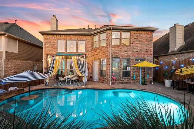 a view of a swimming pool with an outdoor seating