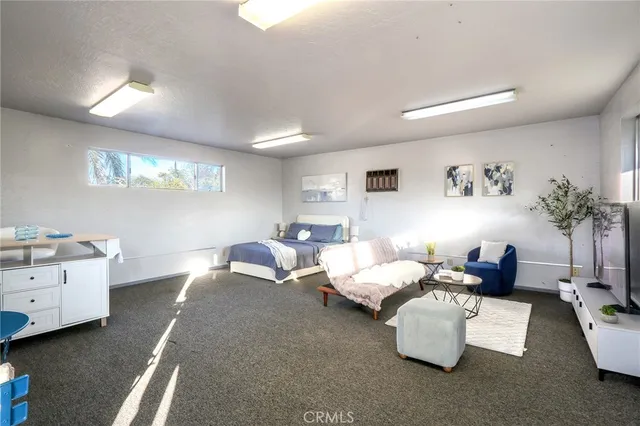 a bedroom with furniture and a wooden floor