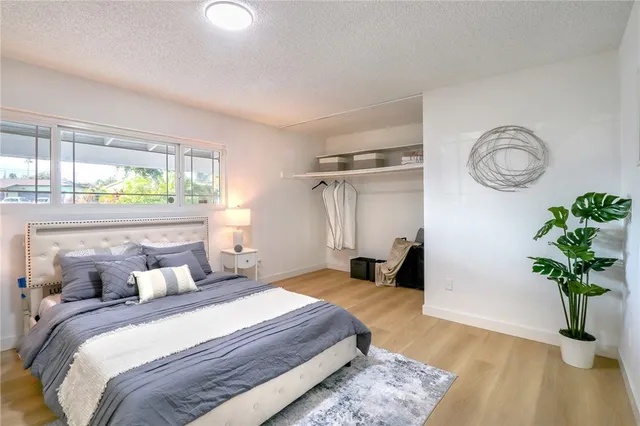 a bedroom with bed and a window