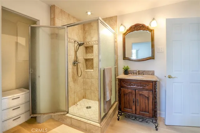 a bathroom with a sink a mirror and a shower