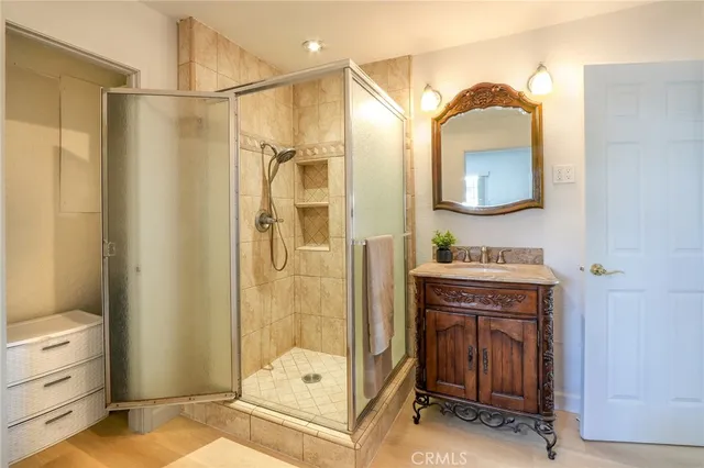 a bathroom with a sink a mirror and a shower