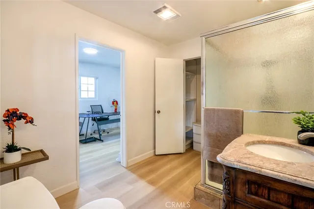 a view of a workspace with furniture and a window