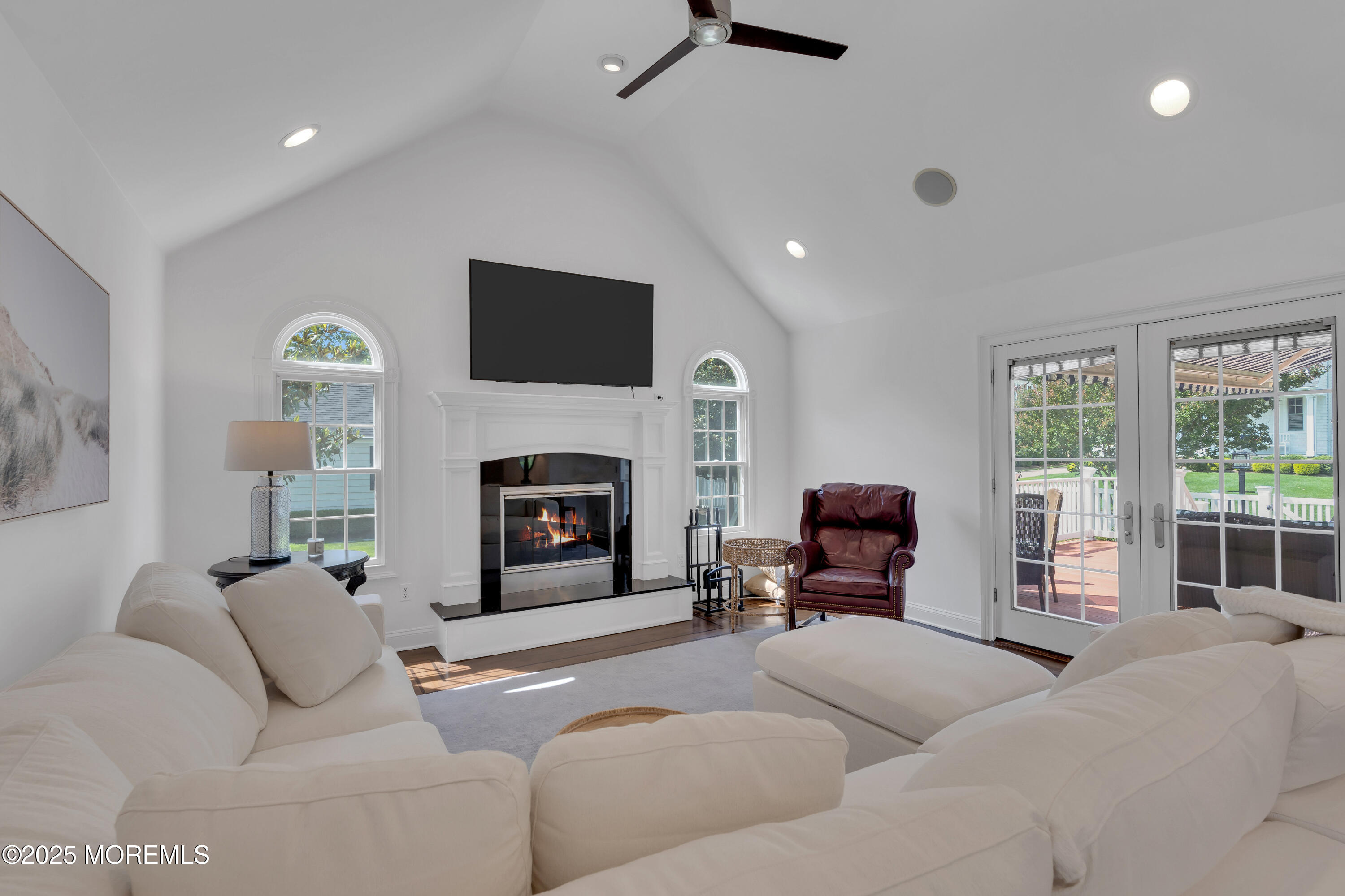 57 River Road Rumson, NJ 07760 - Photo 11 of 44 a living room with furniture a fireplace and a flat screen tv
