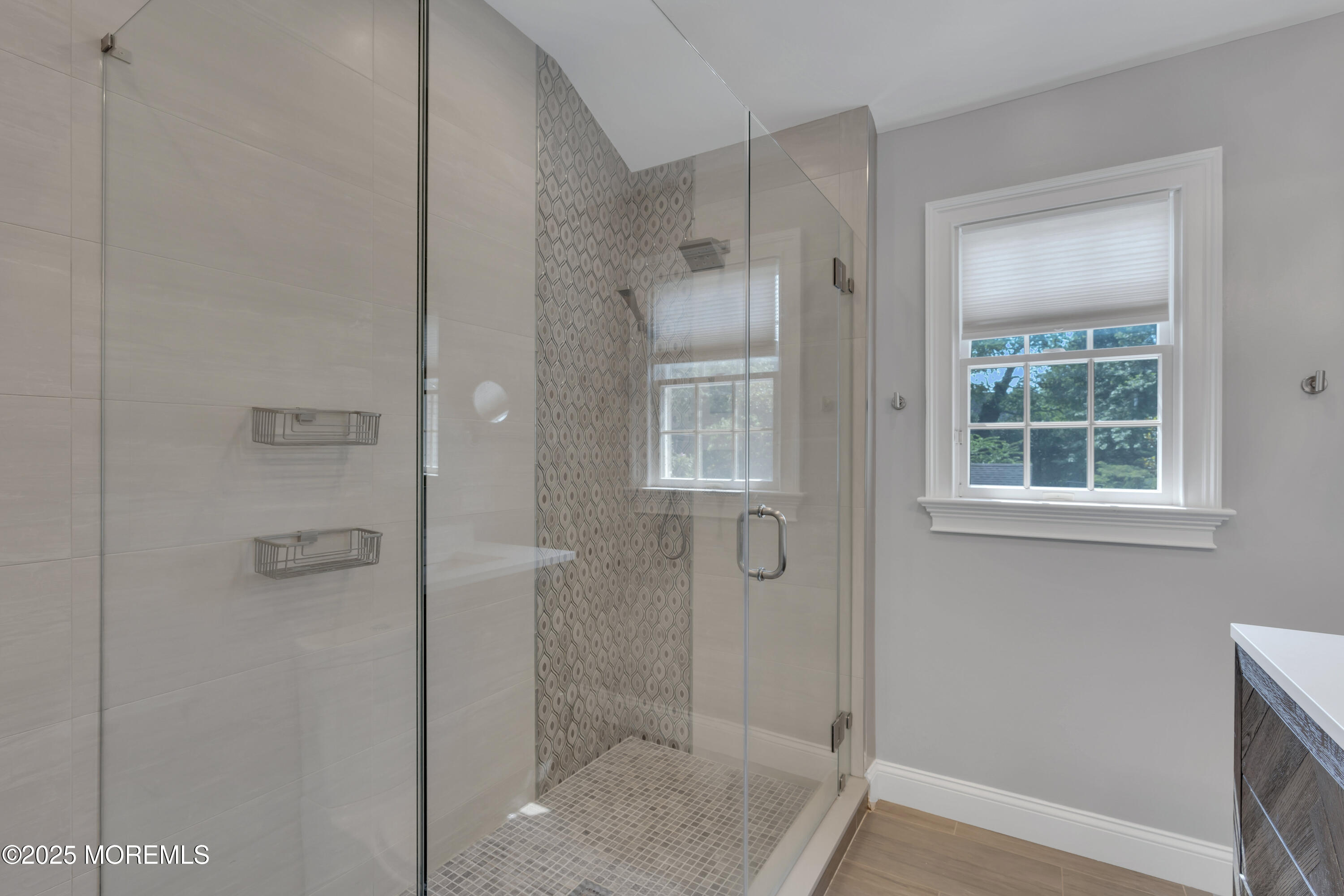 57 River Road Rumson, NJ 07760 - Photo 17 of 44 a bathroom with a glass shower door