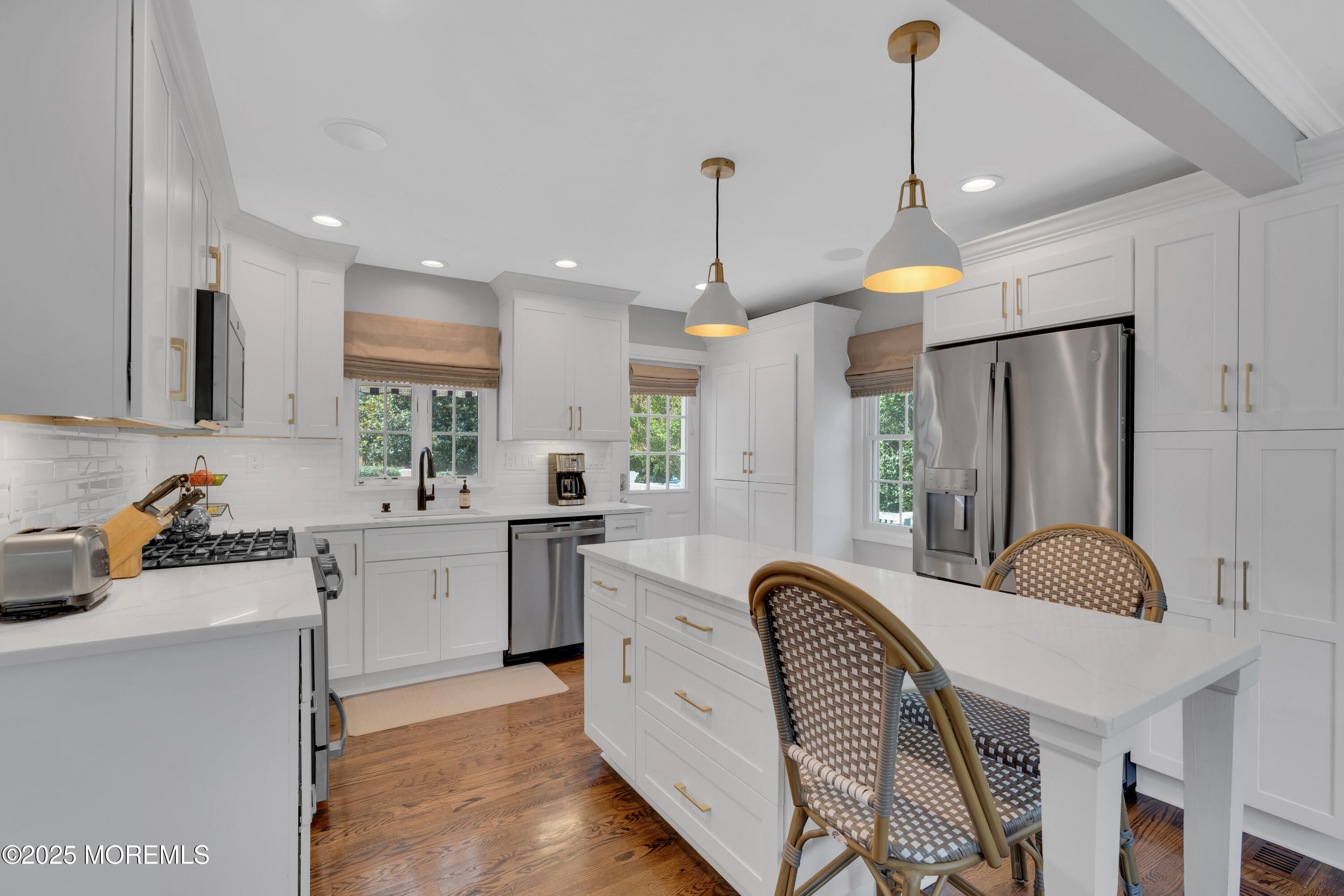 57 River Road Rumson, NJ 07760 - Photo 2 of 44 a large kitchen with kitchen island a sink a center island a stove and a chandelier