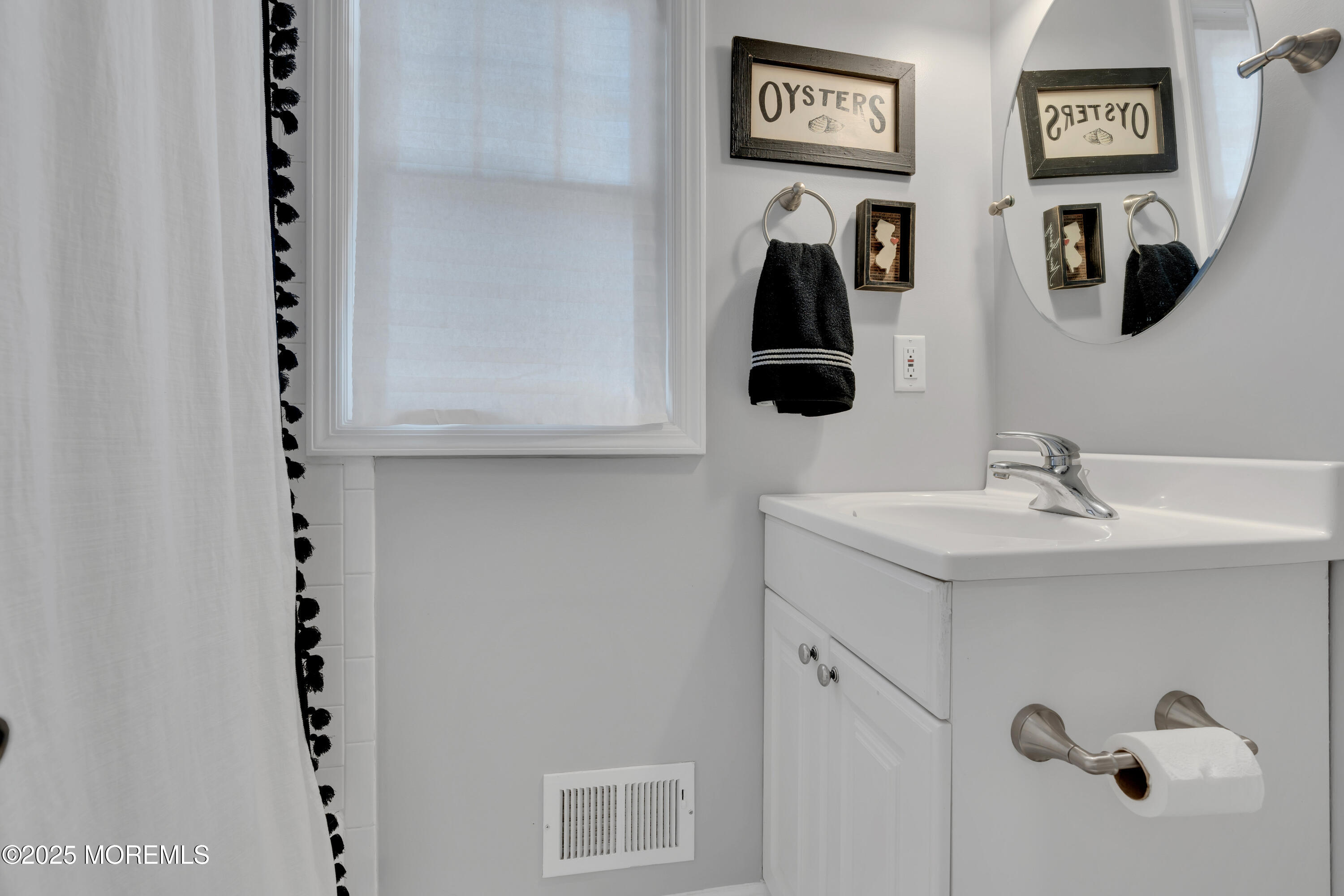57 River Road Rumson, NJ 07760 - Photo 26 of 44 a bathroom with a sink and a mirror