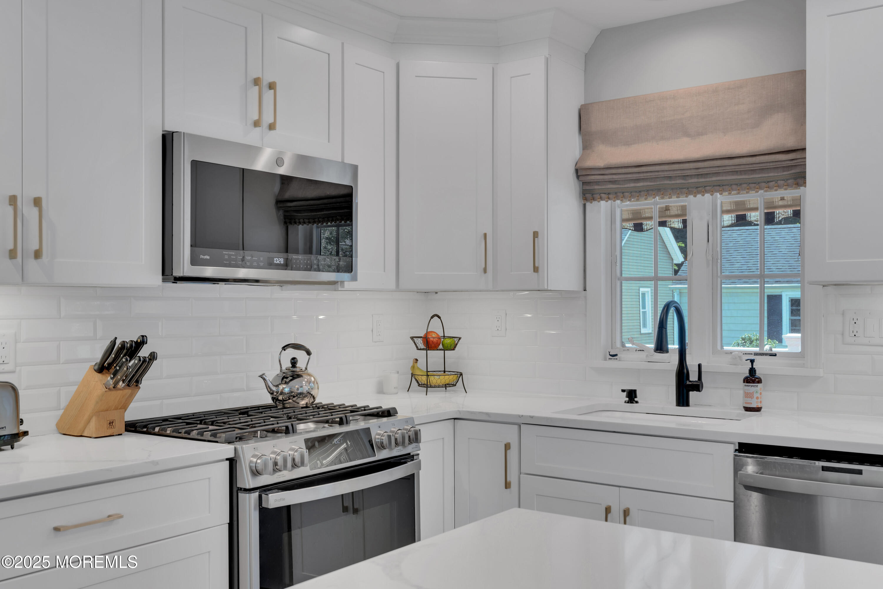 57 River Road Rumson, NJ 07760 - Photo 3 of 44 a kitchen with cabinets stainless steel appliances and wooden floor