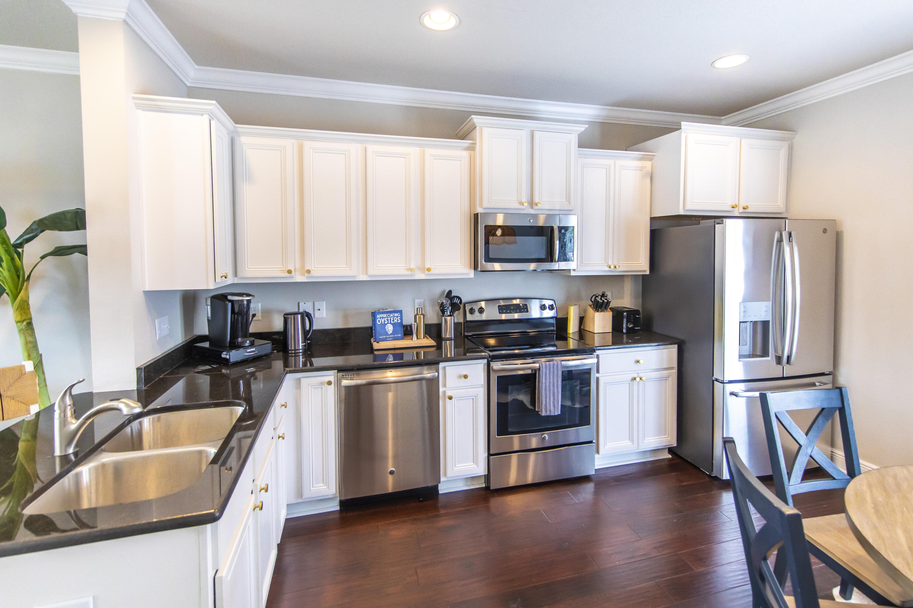74 Grayling Way Inlet Beach, FL 32461 - Photo 8 of 18 a kitchen with stainless steel appliances granite countertop a refrigerator a sink a stove a microwave and wooden cabinets