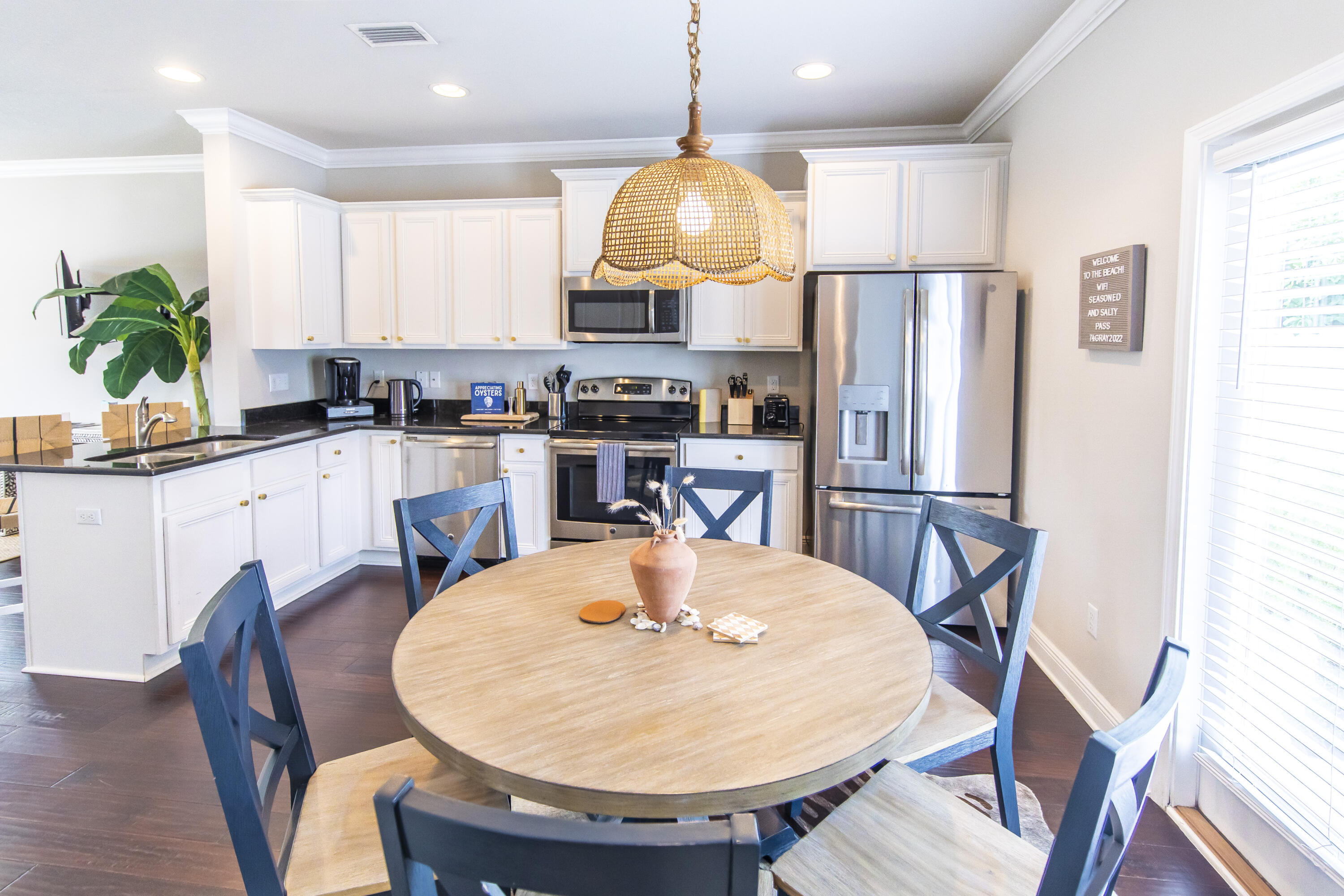 74 Grayling Way Inlet Beach, FL 32461 - Photo 9 of 18 a kitchen with granite countertop a dining table chairs and a refrigerator