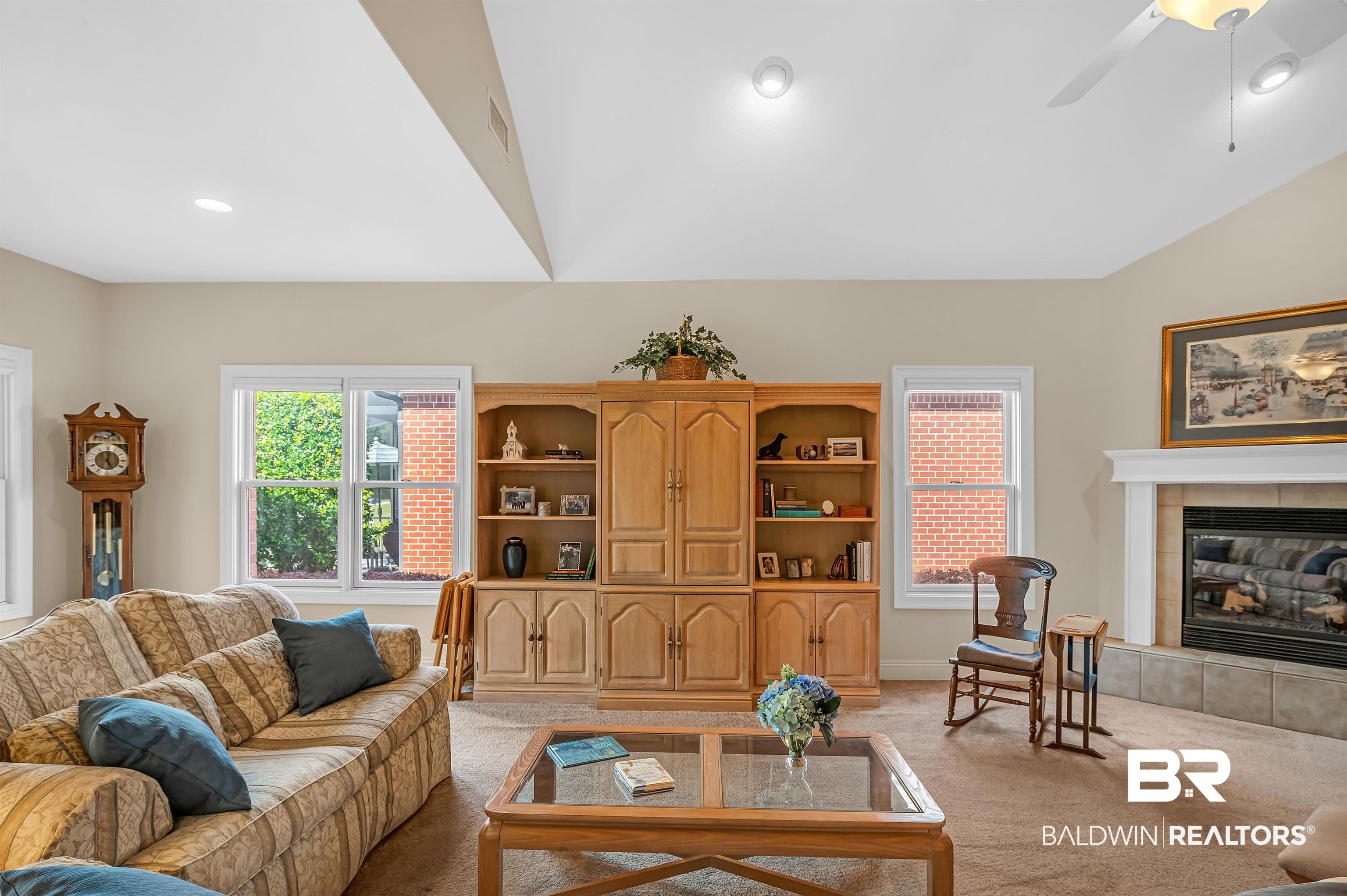 22739 Inverness Way Foley, AL 36535 - Photo 21 of 80 Living area with light carpet, a fireplace, ceiling fan, and vaulted ceiling