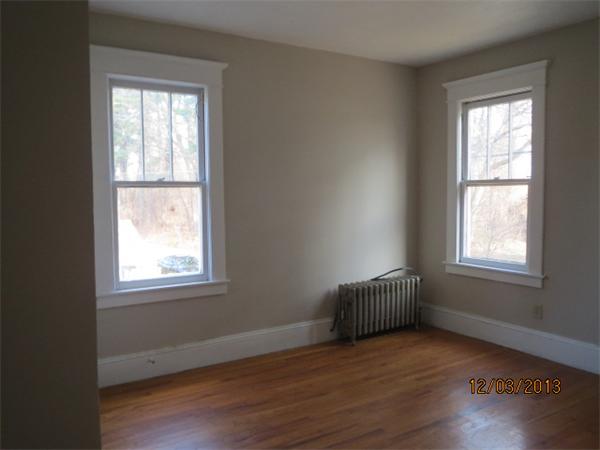 48 St James Circle Springfield, MA 01104 - Photo 6 of 8 a view of an empty room with wooden floor and a window
