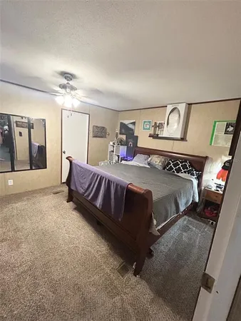 a spacious bedroom with a bed and window